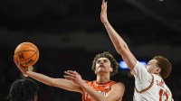 Illinois Fighting Illini guard Keaton Wagler (23) shoots as Maryland Terrapins forward Elijah Saunders (13) and guard George Turkson Jr. (11) defends during the first half at Xfinity Center.