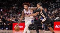 Philadelphia 76ers forward/guard Kelly Oubre Jr. (9) dribbles against Atlanta Hawks guard Gabe Vincent (4) during the first half at State Farm Arena.