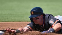 Detroit Tigers shortstop Kevin McGonigle (85) dives back to first base in the first inning against the Atlanta Braves during spring training at CoolToday Park.