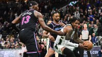 Milwaukee Bucks guard Kevin Porter (7) gets pressure from Miami Heat guard Norman Powell (24) and forward Bam Adebayo (13) in the fourth quarter at Fiserv Forum.