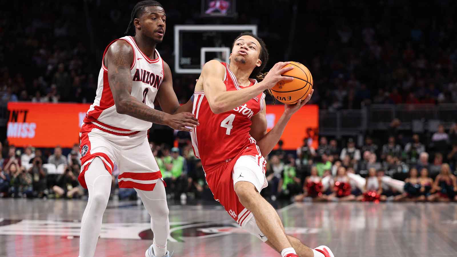Houston Cougars guard Kingston Flemings (4) drives to the hoop past Arizona Wildcats guard Jaden Bradley (0) during the second half during the men's Big 12 Conference Tournament Championship at T-Mobile Center. 