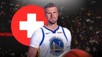 Kristaps Porzingis looking down and sad with a red health cross symbol next to him