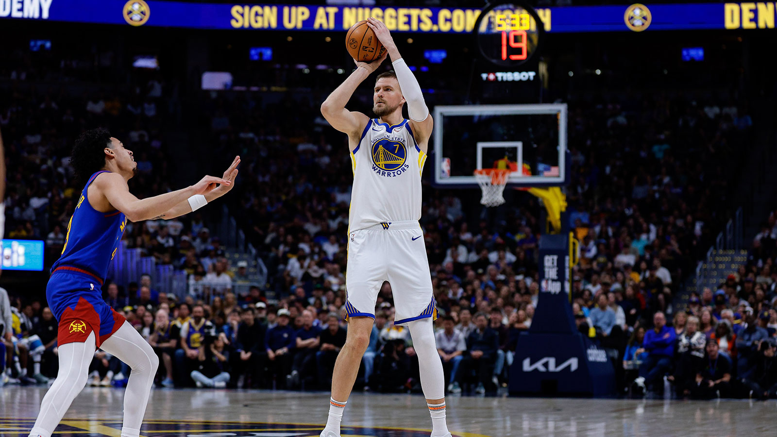Golden State Warriors center Kristaps Porzingis (7) attempts a shot as Denver Nuggets guard Julian Strawther (3) defends in the second quarter at Ball Arena. 
