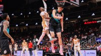 Atlanta Hawks forward Jonathan Kuminga (0) dunks over Portland Trail Blazers center Yang Hansen (16) in the fourth quarter at State Farm Arena.