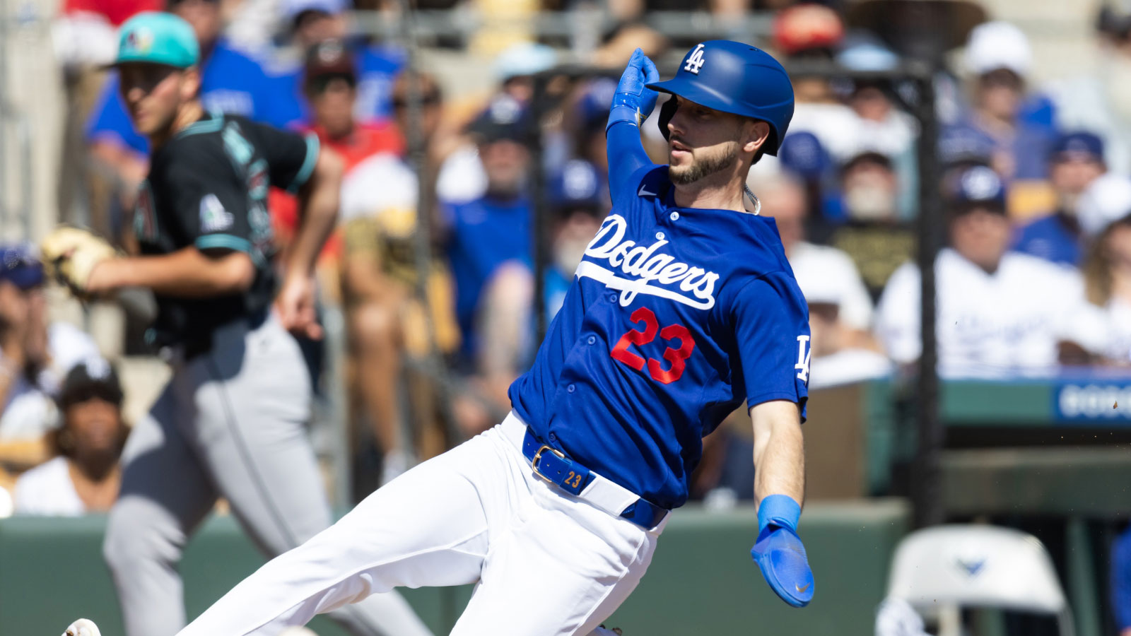 Los Angeles Dodgers base runner Kyle Tucker slides into home to score against the Arizona Diamondbacks during a spring training game at Camelback Ranch-Glendale. 