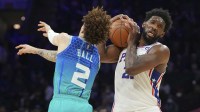 Charlotte Hornets guard LaMelo Ball (2) attempts to steal the ball from Philadelphia 76ers center Joel Embiid (21) in the second half at the Wells Fargo Center.