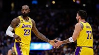 Lakers forward LeBron James (23) and guard Luka Doncic (77) in the first quarter against the Denver Nuggets at Ball Arena