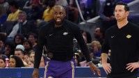 Los Angeles Lakers forward LeBron James (23) coaches his team with Los Angeles Lakers head coach JJ Redick as he waits to enter the game against the Golden State Warriors in the third period at Chase Center.