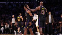 Lakers forward LeBron James (23) greets guard Bronny James