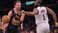 Los Angeles Lakers guard Luka Doncic (77) is defended by Cleveland Cavaliers guard James Harden (1) as he drives to the basket in the first half at Crypto.com Arena.