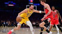 Los Angeles Lakers guard Luka Doncic (77) moves the ball against Chicago Bulls forward Matas Buzelis (14) during the first half at Crypto.com Arena.