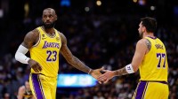 Los Angeles Lakers forward LeBron James (23) and guard Luka Doncic (77) in the first quarter against the Denver Nuggets at Ball Arena.