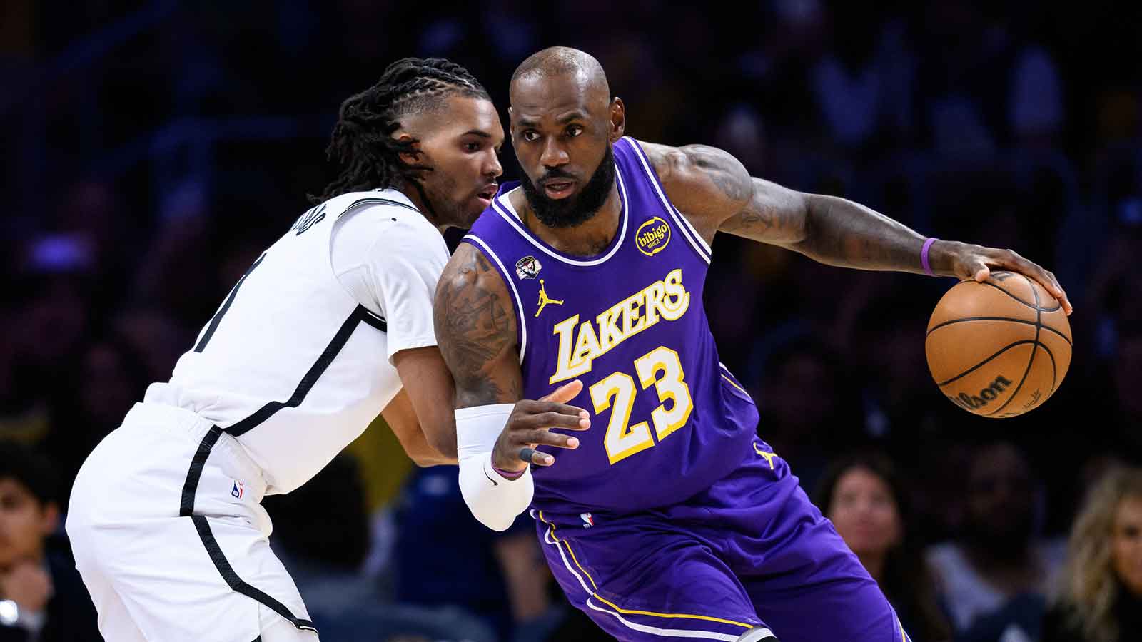 Los Angeles Lakers forward LeBron James (23) dribbles against Brooklyn Nets forward Ziaire Williams (1) during the first half at Crypto.com Arena.