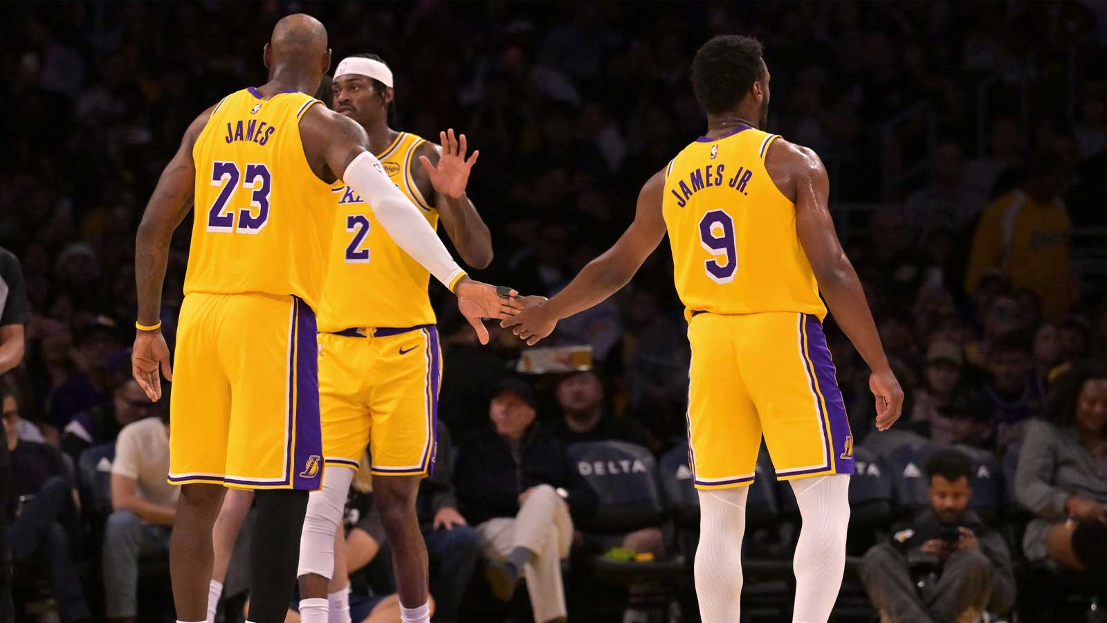 Los Angeles Lakers forward LeBron James (23) gets a tap from guard Bronny James (9) during a stoppage in play in the first half against the Washington Wizards at Crypto.com Arena.