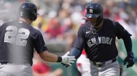 New York Yankees shortstop George Lombard Jr. (96) celebrates a home run in the first inning against the Boston Red Sox with teammate Ben Rice (22) at JetBlue Park at Fenway South.