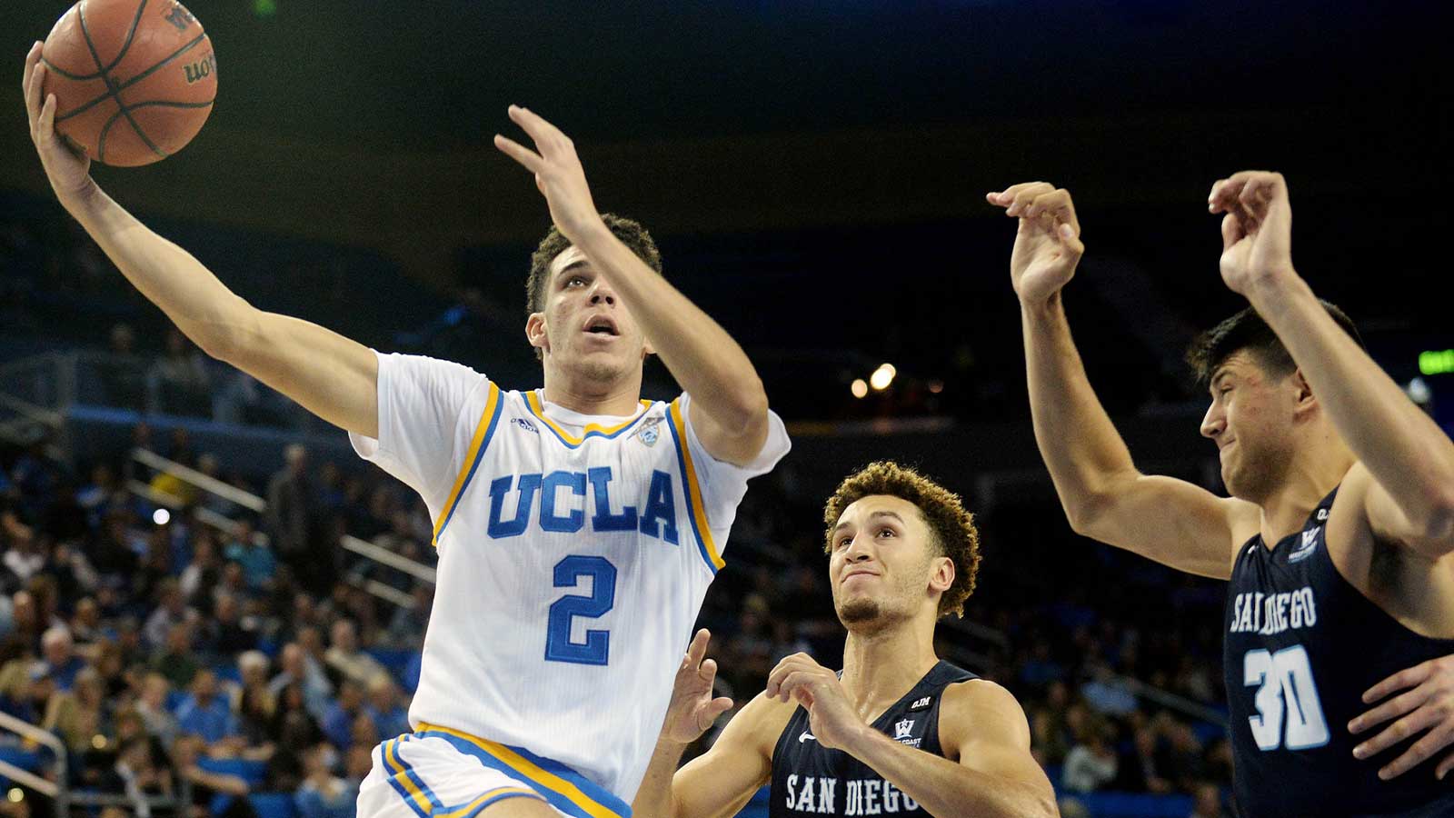 UCLA Bruins guard Lonzo Ball (2) moves to the basket against San Diego Toreros guard Tyler Williams (1) and forward Frank Ryder (30) during the second half at Pauley Pavilion.