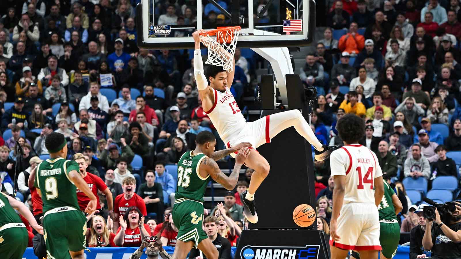 Louisville Cardinals forward Sananda Fru (13) dunks during the second half against the South Florida Bulls during a first round game of the men's 2026 NCAA Tournament at Keybank Center.