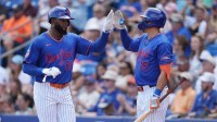 New York Mets center fielder Luis Robert Jr. (88) is congratulated by left fielder Tyrone Taylor (15) after scoring run in the second inning against the Toronto Blue Jays at Clover Park.