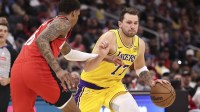 Los Angeles Lakers guard Luka Doncic (77) dribbles the ball as Houston Rockets forward Jabari Smith Jr. (10) defends during the third quarter at Toyota Center.