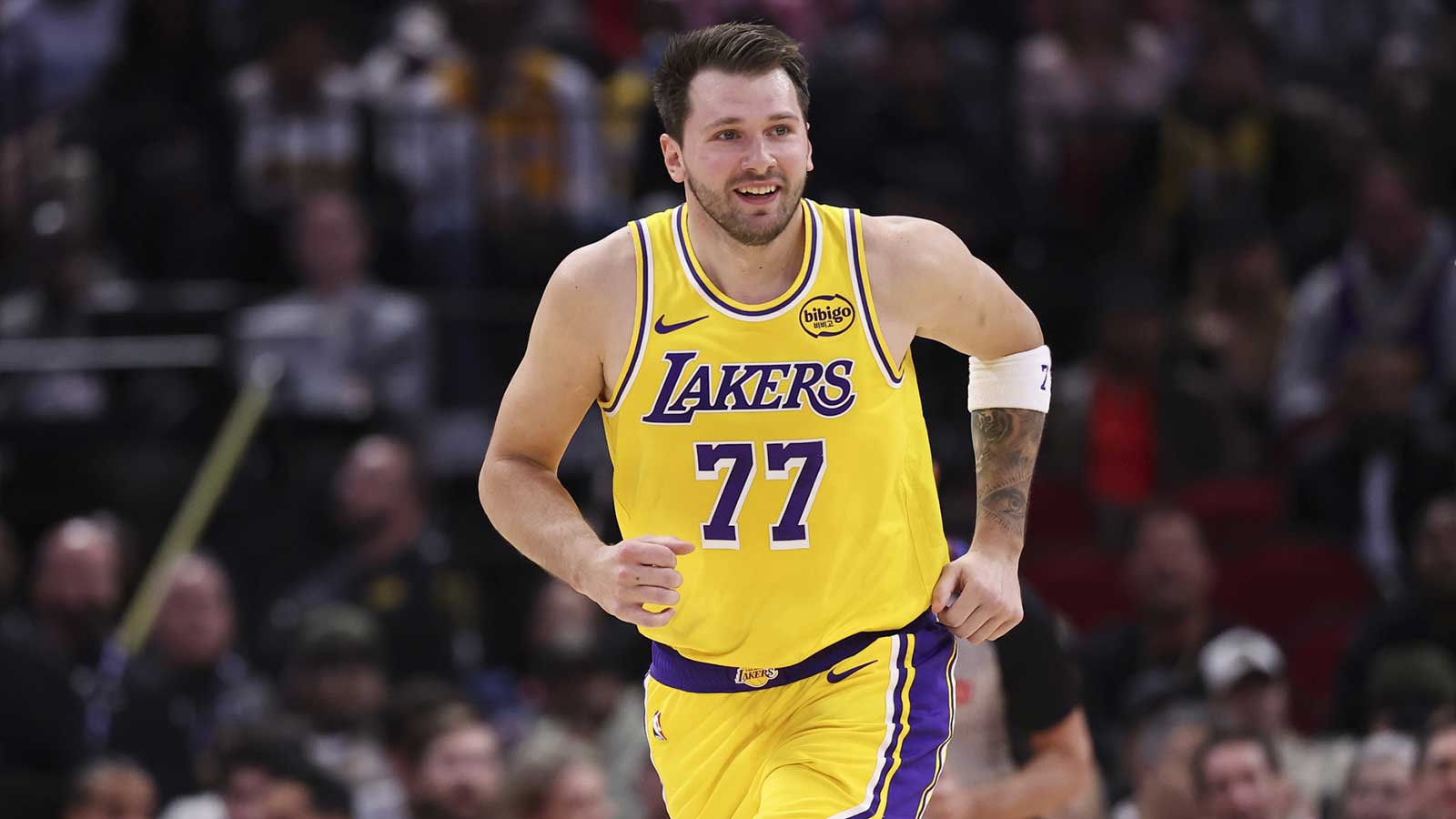 Los Angeles Lakers guard Luka Doncic (77) reacts after scoring a basket during the first quarter against the Houston Rockets at Toyota Center.