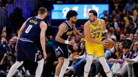 Los Angeles Lakers guard Luka Doncic (77) controls the ball against Denver Nuggets guard Jamal Murray (27) as guard Christian Braun (0) defends in the first quarter at Ball Arena. Mandatory Credit: Isaiah J. Downing-Imagn Images