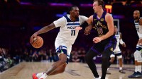 Minnesota Timberwolves center Naz Reid (11) moves the ball against Los Angeles Lakers guard Luke Kennard (10) during the second half at Crypto.com Arena.
