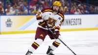 Minnesota defenseman Luke Mittelstadt (20)controls the puck against Boston University in the first period in the semifinals of the 2023 Frozen Four college ice hockey tournament at Amalie Arena.