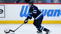 Winnipeg Jets defenseman Luke Schenn (5) looks to pass against the Chicago Blackhawks during the third period at Canada Life Centre. Mandatory Credit: Terrence Lee-Imagn Images