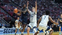 Utah State Aggies guard Mj Collins (2) controls the ball against Villanova Wildcats forward Duke Brennan (24) in the first half during a first round game of the men's 2026 NCAA Tournament at Viejas Arena.