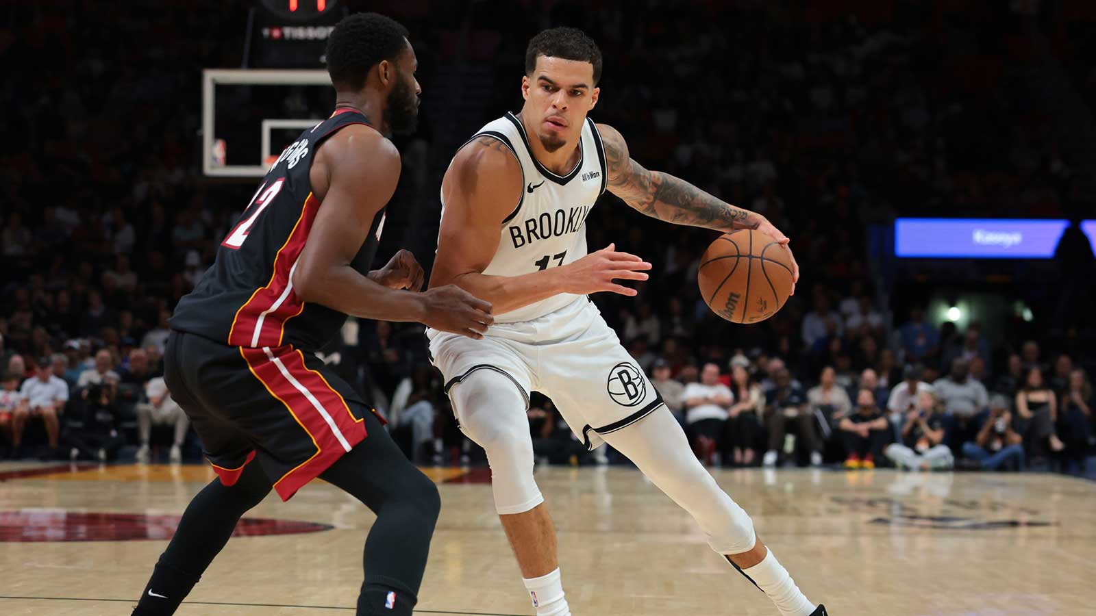 Brooklyn Nets forward Michael Porter Jr. (17) drives to the basket against Miami Heat forward Andrew Wiggins (22) during the second quarter at Kaseya Center.