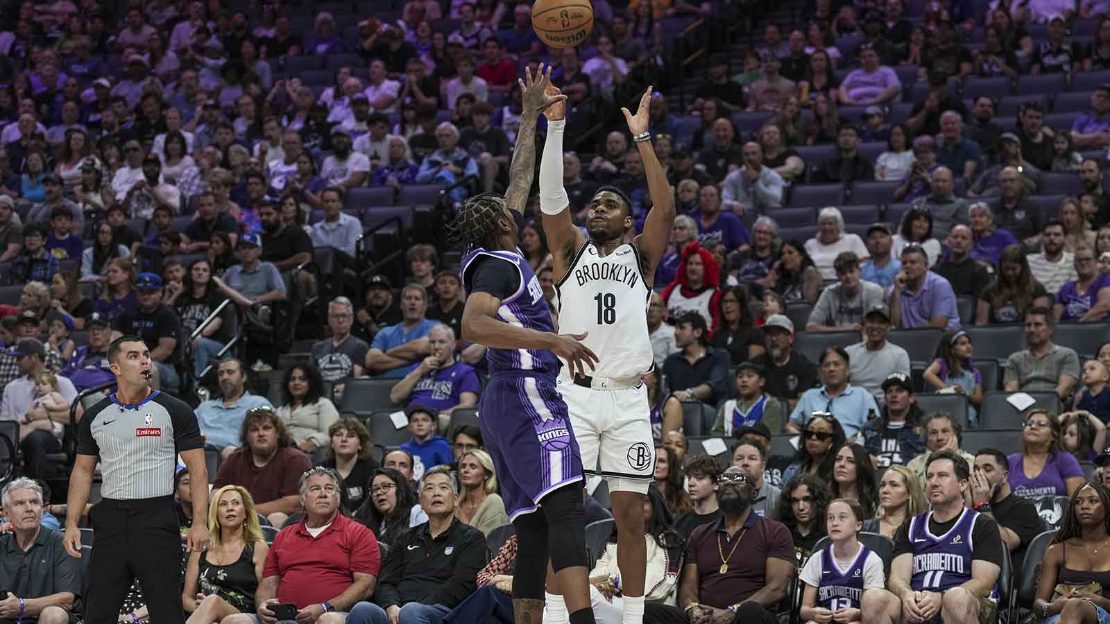 Brooklyn Nets guard Malachi Smith (18) shoots a three point basket over Sacramento Kings guard Malik Monk (0) during the first quarter at Golden 1 Center.