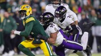 Green Bay Packers quarterback Malik Willis (2) is tackled by Baltimore Ravens linebacker Tavius Robinson (95) on Saturday, December 27, 2025, at Lambeau Field in Green Bay, Wis. The Ravens won the game, 41-24.