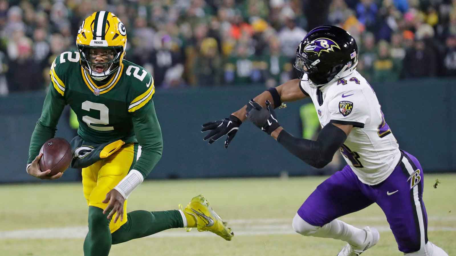 Green Bay Packers quarterback Malik Willis (2) breaks away from Baltimore Ravens cornerback Marlon Humphrey (44) to score a touchdown in the second quarter at Lambeau Field in Green Bay, Wisconsin. 