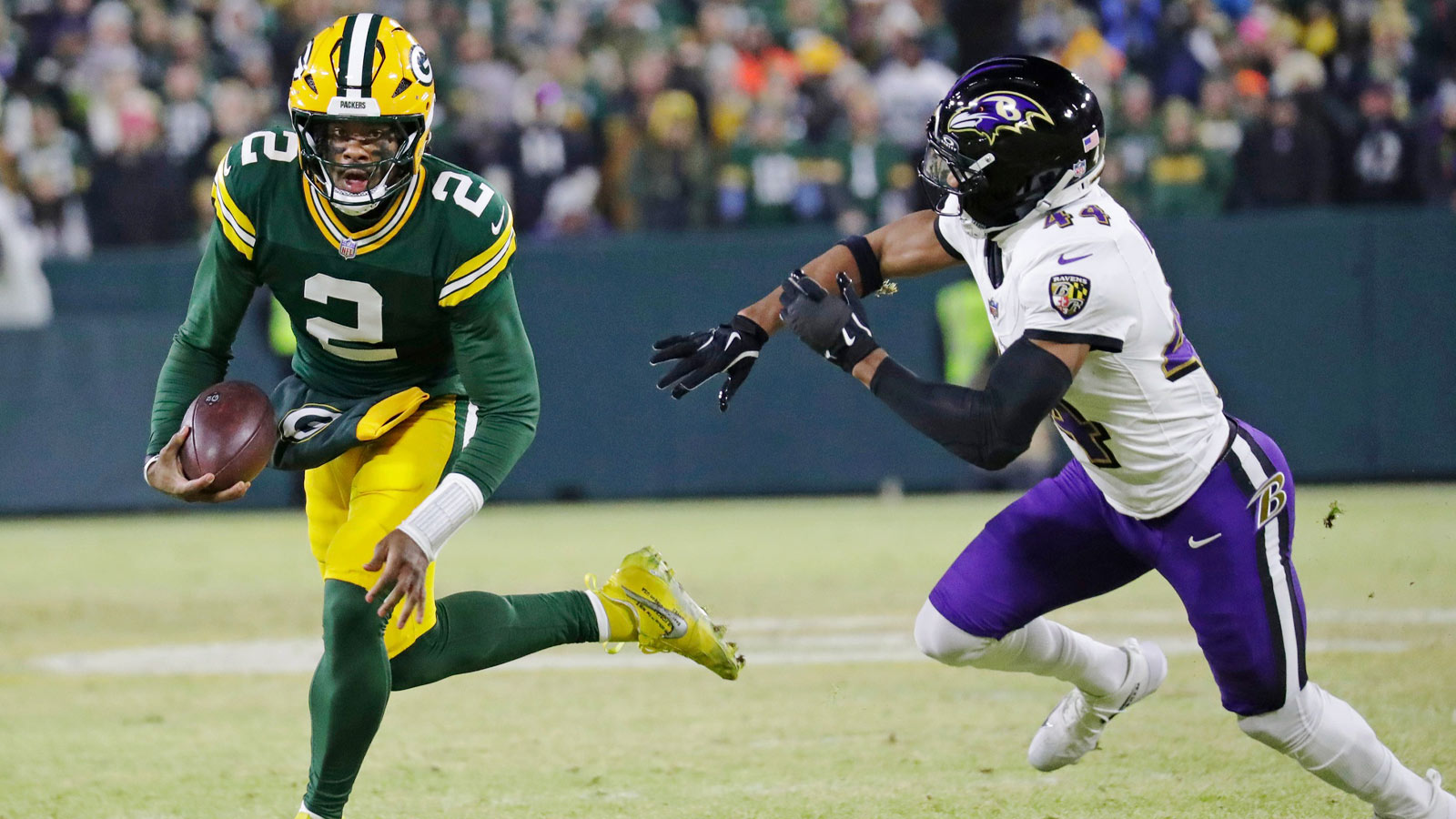Green Bay Packers quarterback Malik Willis (2) breaks away from Baltimore Ravens cornerback Marlon Humphrey (44) to score a touchdown in the second quarter at Lambeau Field in Green Bay, Wisconsin.