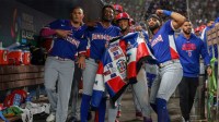 Dominican Republic second baseman Ketel Marte (4) celebrates with third baseman Manny MacHado (3), shortstop Geraldo Perdomo (2), and right fielder Fernando Tatis Jr. (23) after hitting a home run against Venezuela during the third inning at loanDepot Park.