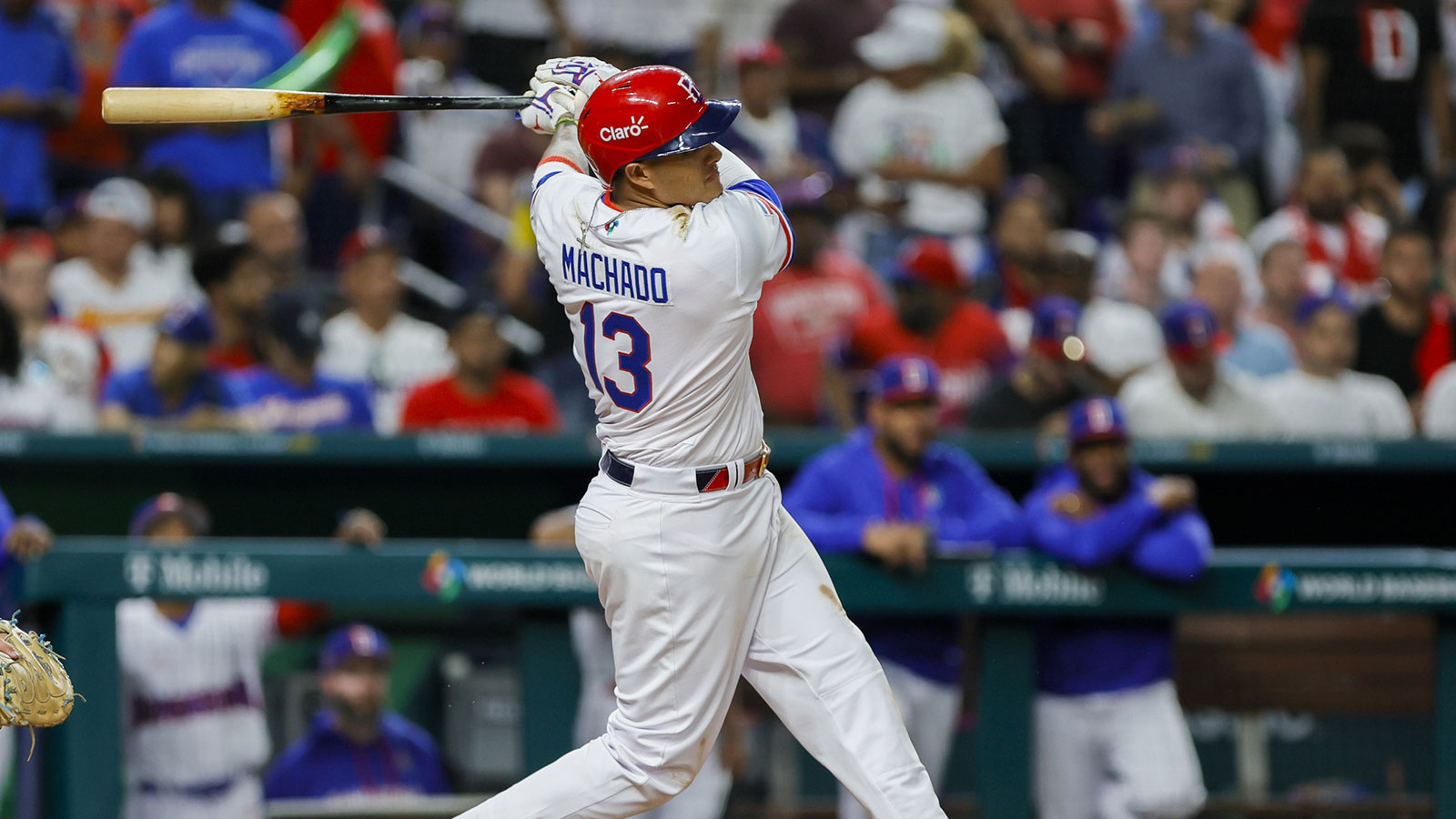 Dominican Republic third baseman Manny Machado (13) hits a two-run single during the sixth inning against Israel at LoanDepot Park