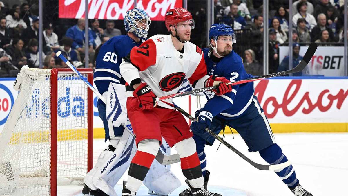 Toronto Maple Leafs defenseman Simon Benoit (2) tries to push Carolina Hurricanes forward Andrei Svechnikov (37) away from the goal area of goalie Joseph Woll (60) in the first period at Scotiabank Arena.