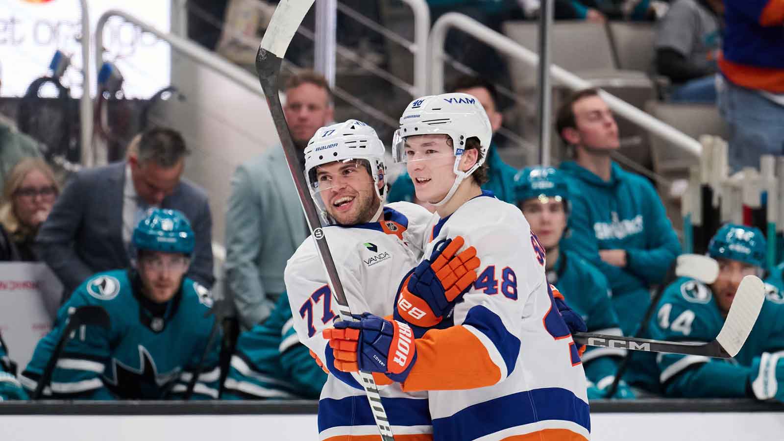New York Islanders defenseman Tony DeAngelo (77) celebrates with defenseman Matthew Schaefer (48) after scoring a goal against San Jose Sharks goaltender Yaroslav Askarov (not pictured) during the first period at SAP Center at San Jose.