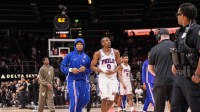 Philadelphia 76ers guard Tyrese Maxey (0) reacts and is assisted after being injured against the Atlanta Hawks during the second half at State Farm Arena.