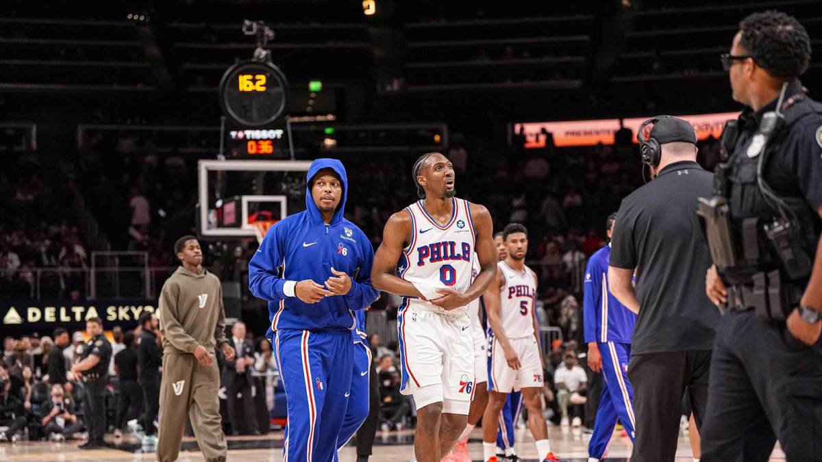 Philadelphia 76ers guard Tyrese Maxey (0) reacts and is assisted after being injured against the Atlanta Hawks during the second half at State Farm Arena.