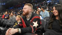 Las Vegas Raiders defensive end Maxx Crosby (left) and wife Rachel Washburn attend the game between the Golden State Warriors and the LA Clippers at the Intuit Dome. Mandatory Credit: Kirby Lee-Imagn Images