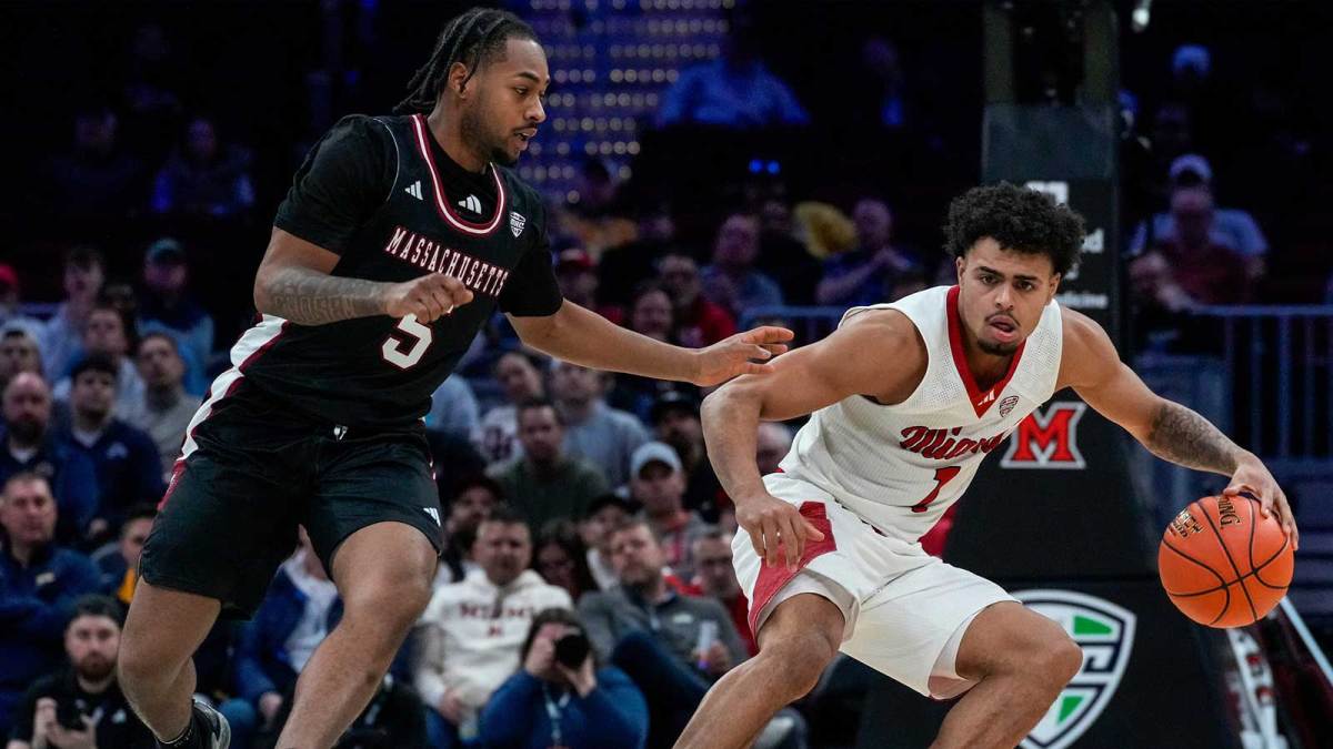 Miami RedHawks guard Trey Perry (1) is guarded by UMass Minutemen guard K'jei Parker (5) in the second half of Mid-American Conference Tournament first round game between the Miami RedHawks and the UMass Minutemen at Rocket Arena in Cleveland on Thursday, March 12, 2026. Top-seeded Miami was eliminated from the tournament with an 87-82 loss to the Minutemen.