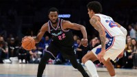 Miami Heat forward Andrew Wiggins (22) drives to the basket against Philadelphia 76ers forward Dominick Barlow (25) during the first quarter at Kaseya Center.
