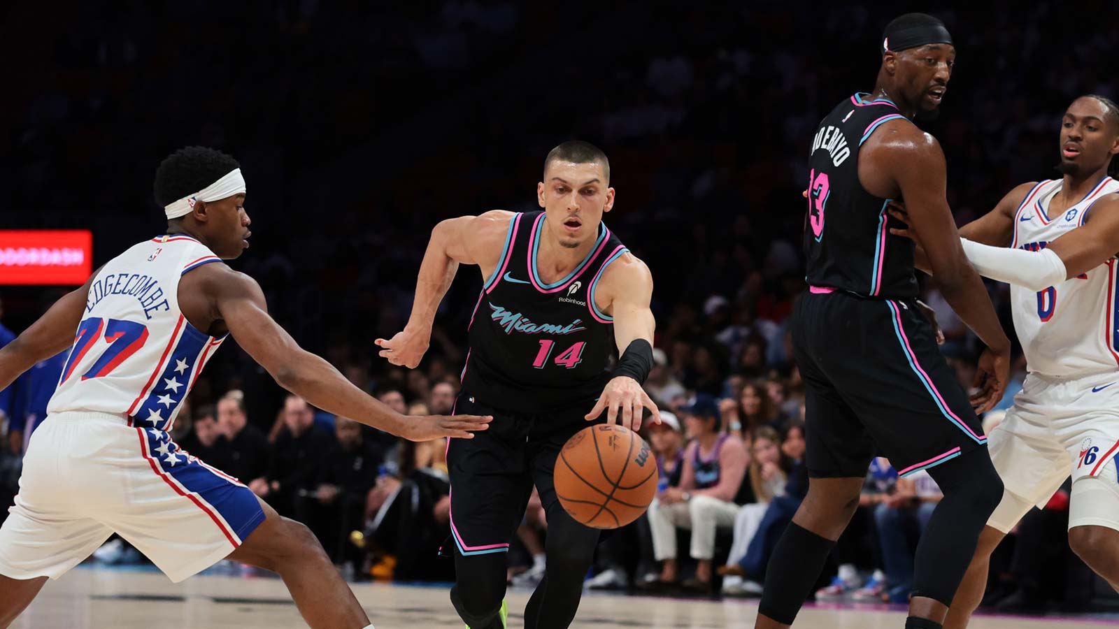 Miami Heat guard Tyler Herro (14) drives to the basket against Philadelphia 76ers guard Vj Edgecombe (77) during the first quarter at Kaseya Center.