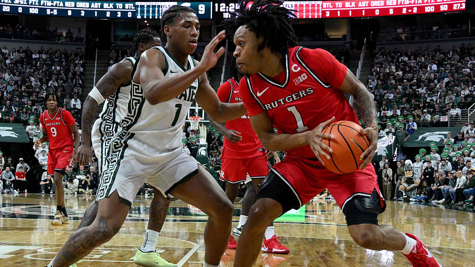 Michigan State Spartans guard Jeremy Fears Jr. (1) defends on Rutgers Scarlet Knights guard Jamichael Davis (1) during the first half at Jack Breslin Student Events Center.