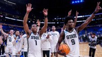 Michigan State guard Jeremy Fears Jr. (1), left, guard Trey Fort (9), right, and teammates wave at fans to celebrate 77-69 win over Louisville at the NCAA Tournament Second Round at KeyBank Center in Buffalo on Saturday, March 21, 2026.