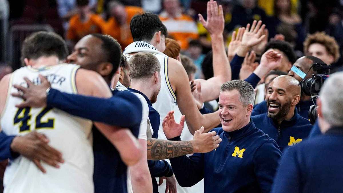 Michigan head coach Dusty May high-fives players to celebrate 95-62 win over Tennessee at the NCAA Tournament Elite 8 round at United Center in Chicago on Sunday, March 29, 2026.