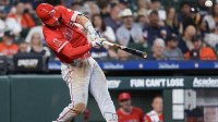 Los Angeles Angels right fielder Mike Trout (27) hits a home run against the Houston Astros in the seventh inning at Daikin Park.