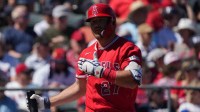 Los Angeles Angels right fielder Mike Trout (27) reacts after missing a pitch against the Cleveland Guardians in the first inning at Tempe Diablo Stadium.
