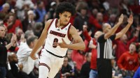 Louisville Cardinals guard Mikel Brown Jr. (0) reacts after making a three pointer against the Kentucky Wildcats during the first half at KFC Yum! Center.